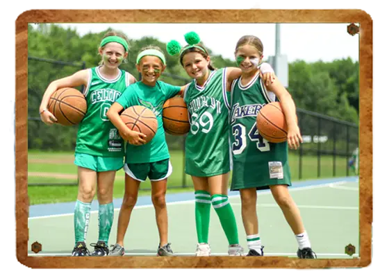 Campers playing basketball in green jerseys at Trails End Camp in Beach Lake, PA