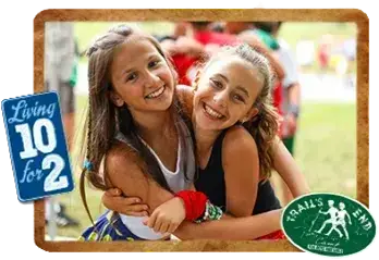 two camper girls smiling together