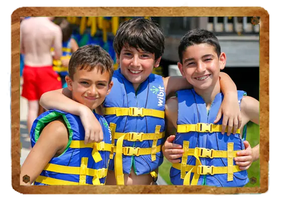 Campers wearing life vests during waterfront activities at Trails End Camp in Beach Lake, PA