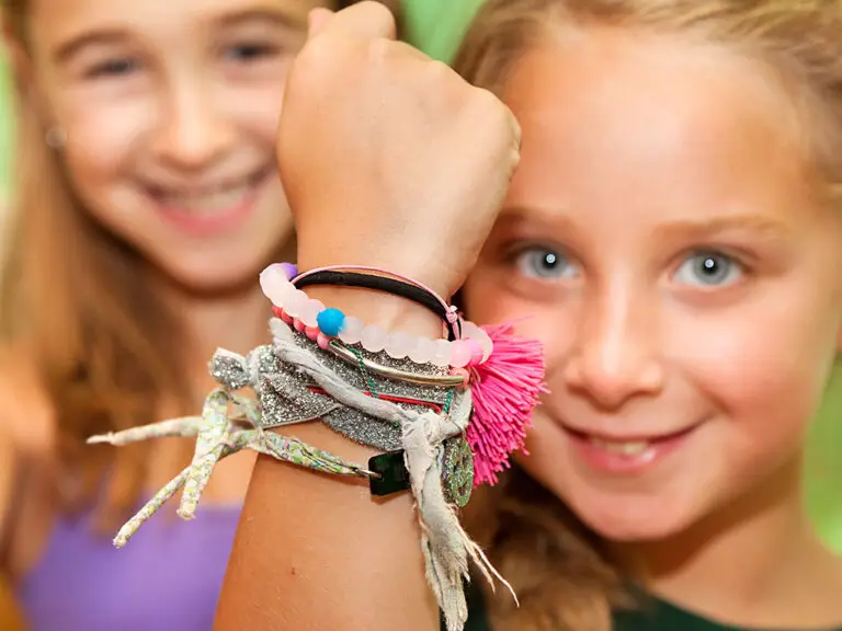 Camper showcasing creative art project at Trails End Camp