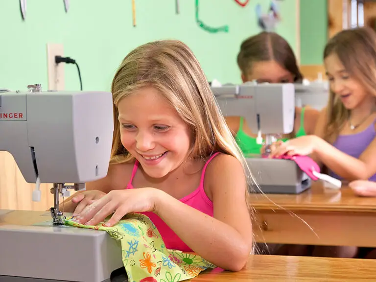 Campers using sewing machines during a typical camp day at Trails End Camp